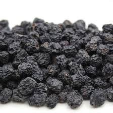Close-up of plump, dark purple dries aronia berries